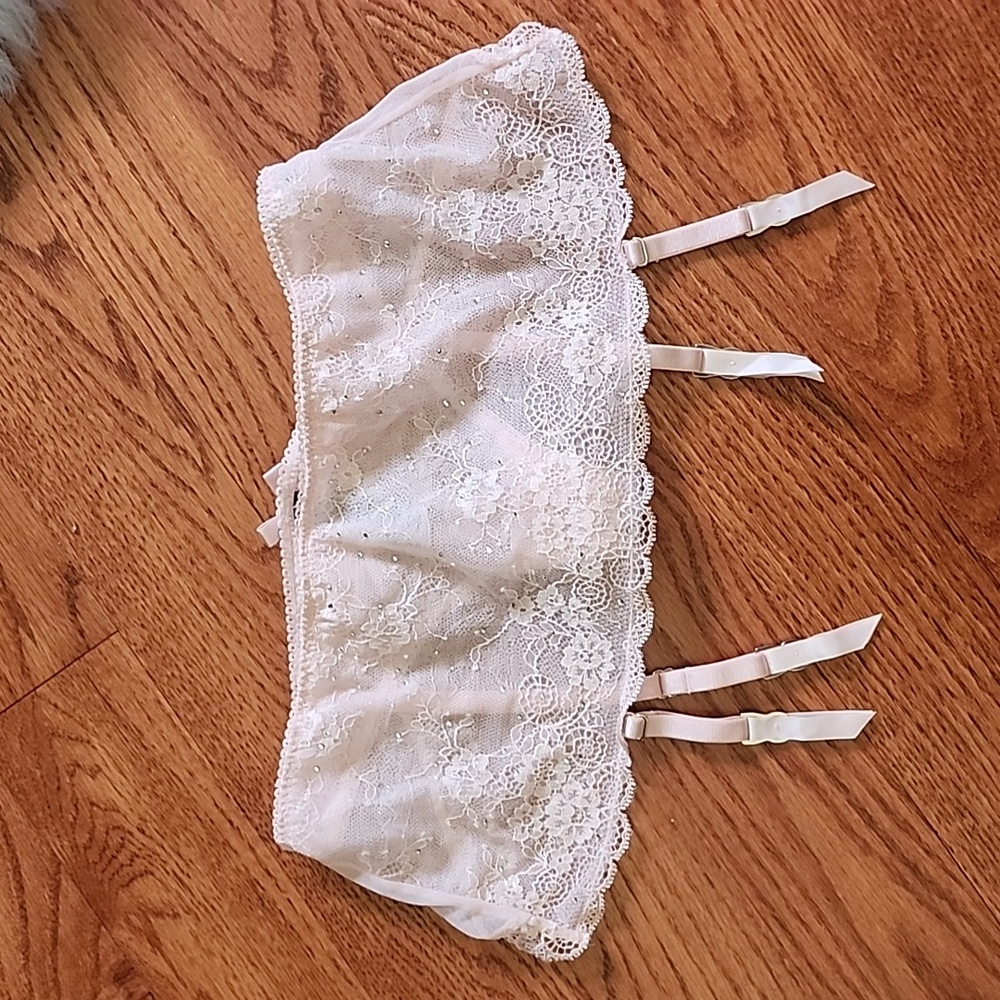 Victoria's secret small garter w/thong attached. Light pink with crystals. New